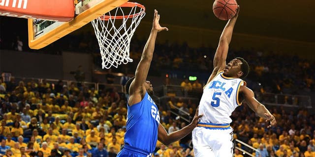 LOS ANGELES, CA - DECEMBER 03: Prince Ali #5 of the UCLA Bruins dunks over Alex Poythress #22 of the Kentucky Wildcats during an 87-77 UCLA win at Pauley Pavilion on December 3, 2015 in Los Angeles, California. (Photo by Harry How/Getty Images)