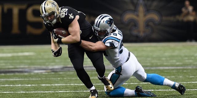 Josh Hill #89 of the New Orleans Saints is brought down by Luke Kuechly #59 of the Carolina Panthers during a game at the Mercedes-Benz Superdome on December 6, 2015 in New Orleans, Louisiana. Carolina defeated New Orleans 41-38. (Photo by Stacy Revere/Getty Images)