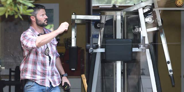 Dec. 9, 2015: A Federal police officer walks through the garage at the home of a Sydney man in Sydney, Australia as they search the property as part of a tax investigation.