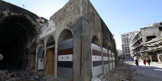 Dec. 9, 2015: Damaged shops are seen with new doors in the old city of Homs, Syria.