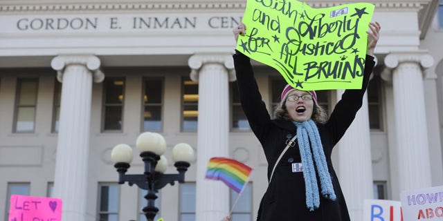 Dec. 8: Belmont University senior Lindsey Thompson holds up a sign during rally in support of former women's soccer coach Lisa Howe, at the university in Nashville, Tenn.