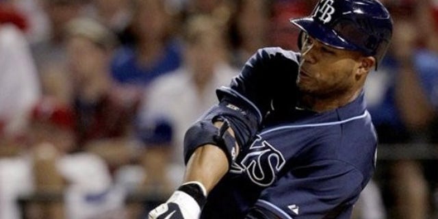 Oct. 9: Tampa Bay Rays left fielder Carl Crawford scores a solo home run against Texas Rangers relief pitcher Neftali Feliz during the ninth inning of the American League Division Series baseball game in Arlington, Texas.