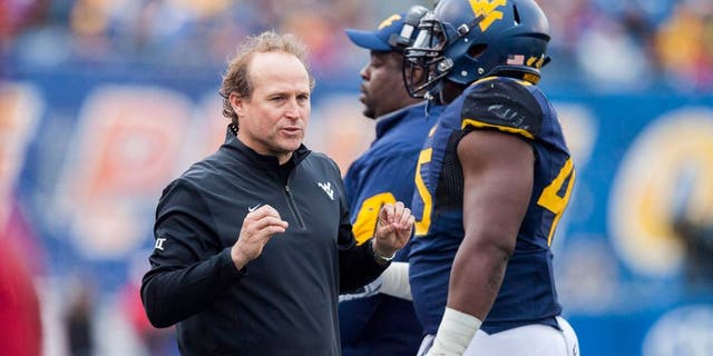 Nov 28, 2015; Morgantown, WV, USA; West Virginia Mountaineers head coach Dana Holgorsen talks with players on the sideline during the second quarter against the Iowa State Cyclones at Milan Puskar Stadium. Mandatory Credit: Ben Queen-USA TODAY Sports