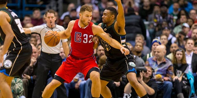 Dec 9, 2015; Milwaukee, WI, USA; Los Angeles Clippers forward Blake Griffin (32) drives for the basket as Milwaukee Bucks forward Jabari Parker (12) defends during the fourth quarter at BMO Harris Bradley Center. The Clippers won 109-95. Mandatory Credit: Jeff Hanisch-USA TODAY Sports
