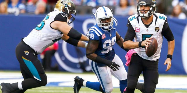 Oct 4, 2015; Indianapolis, IN, USA; Jacksonville Jaguars quarterback Blake Bortles (5) runs away from Indianapolis Colts linebacker Robert Mathis (98) at Lucas Oil Stadium. Indianapolis defeats Jacksonville 16-13 in overtime. Mandatory Credit: Brian Spurlock-USA TODAY Sports