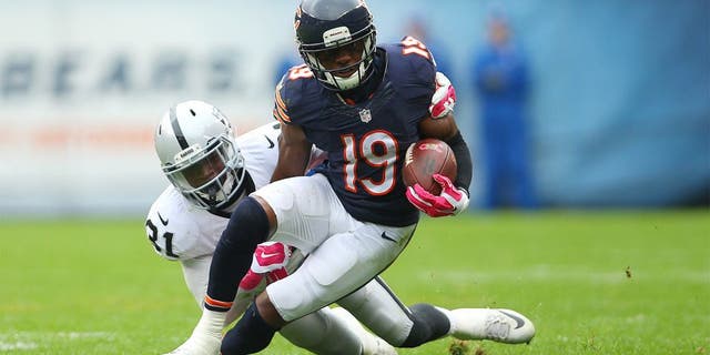 Oct 4, 2015; Chicago, IL, USA; Chicago Bears wide receiver Eddie Royal (19) is tackled by Oakland Raiders cornerback Neiko Thorpe (31) during the second half at Soldier Field. Mandatory Credit: Jerry Lai-USA TODAY Sports