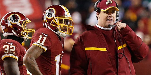 Dec 20, 2014; Landover, MD, USA; Washington Redskins head coach Jay Gruden (R) talks to Redskins wide receiver DeSean Jackson (11) on the sidelines against the Philadelphia Eagles in the fourth quarter at FedEx Field. The Redskins won 27-24. Mandatory Credit: Geoff Burke-USA TODAY Sports