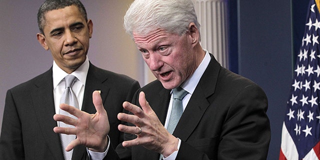Dec. 10: President Obama looks on as former President Bill Clinton speaks in the briefing room of the White House in Washington.