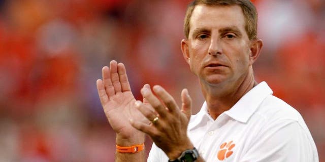 CLEMSON, SC - AUGUST 31: Dabo Swinney Head Coach of the Clemson Tigers directs warmups prior to the game against the Georgia Bulldogs at Memorial Stadium on August 31, 2013 in Clemson, South Carolina. (Photo by Tyler Smith/Getty Images)