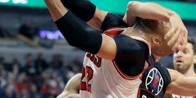 Los Angeles Clippers forward Blake Griffin (32) fouls Chicago Bulls forward Taj Gibson during the second half of an NBA basketball game on Thursday, Dec. 10, 2015, in Chicago. (AP Photo/Nam Y. Huh)