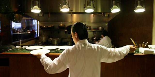 December 7, 2011: Workers prepare for lunch in the kitchen at the Palio D'Asti restaurant in San Francisco.