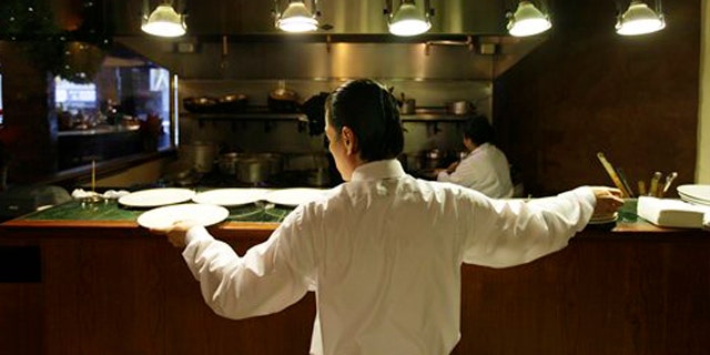 December 7, 2011: Workers prepare for lunch in the kitchen at the Palio D'Asti restaurant in San Francisco.