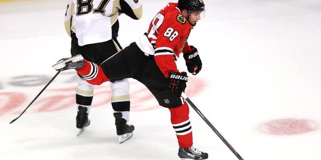 CHICAGO, IL - SEPTEMBER 19: Patrick Kane #88 of the Chicago Blackhawks leaps to avoid colliding with Sidney Crosby #87 of the Pittsburgh Penguins during an exhibition game at United Center on September 19, 2013 in Chicago, Illinois. The Penguins defeated the Blackhawks 4-3 in a shootout. (Photo by Jonathan Daniel/Getty Images)