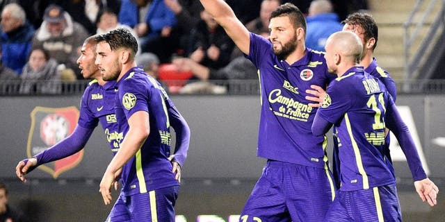 Caen's French defender Syam Ben Youssef (3-R) celebrates with teammates after scoring a goal during the French L1 football match Rennes against Caen on December 11, 2015 at the Roazhon park stadium in Rennes, western France. AFP PHOTO / DAMIEN MEYER / AFP / DAMIEN MEYER (Photo credit should read DAMIEN MEYER/AFP/Getty Images)