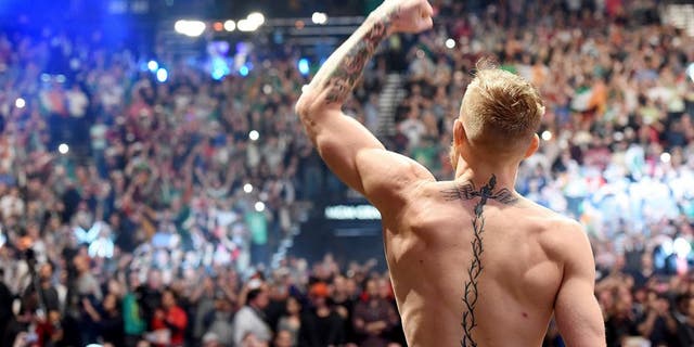 LAS VEGAS, NV - DECEMBER 11: UFC interim featherweight champion Conor McGregor of Ireland waves to the crowd after making weight during the UFC 194 weigh-in inside MGM Grand Garden Arena on December 10, 2015 in Las Vegas, Nevada. (Photo by Mike Roach/Zuffa LLC/Zuffa LLC via Getty Images)