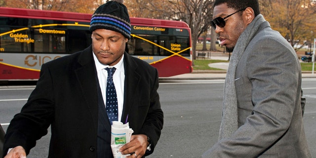 FILE - In this Nov. 30, 2012, file photo, New Orleans Saints football defensive end Will Smith, left, and linebacker Jonathan Vilma arrive at an attorney's office in Washington, for a hearing on their appeals of bounties suspensions.