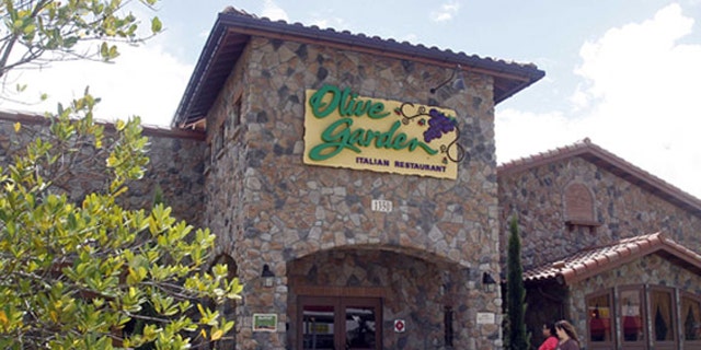 An Olive Garden restaurant is shown in Hialeah, Fla., Thursday, Sept. 6, 2012. Servers at Olive Garden, Red Lobster and other eateries are suing the restaurants' parent company, claiming they were cheated out of overtime pay and not allowed to clock-in until customers arrived. The federal lawsuit against Darden Restaurants seeks back pay and other compensation, plus interest and attorney's fees. (AP Photo/Alan Diaz)