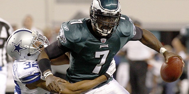 December 12: Dallas Cowboys cornerback Orlando Scandrick dismisses Philadelphia Eagles quarterback Michael Vick (7) during the second half of an NFL football game in Arlington, Texas.