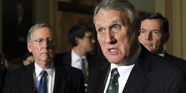 Nov. 30: Senate Minority Whip Jon Kyl of Ariz., center, accompanied by Senate Minority Leader Sen. Mitch McConnell of Ky., left, and Sen. John Barrasso, R-Wyo., speaks to reporters during a news conference on Capitol Hill in Washington.