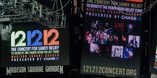 Signs are lit on the scoreboard for the 12-12-12 fundraising concert at Madison Square Garden to raise funds for victims of Hurricane Sandy in New York, December 11, 2012.   REUTERS/Lucas Jackson (UNITED STATES - Tags: ENTERTAINMENT) - RTR3BGJL