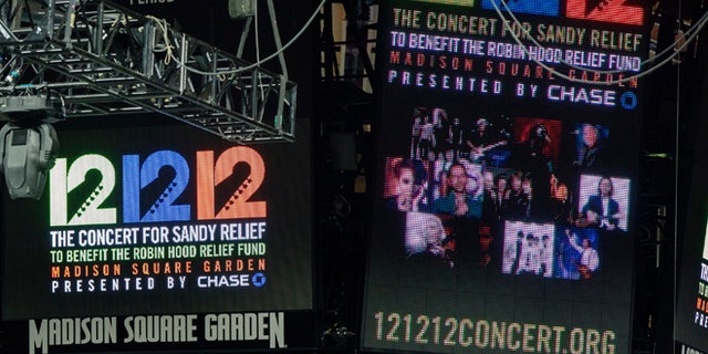 Signs are lit on the scoreboard for the 12-12-12 fundraising concert at Madison Square Garden to raise funds for victims of Hurricane Sandy in New York, December 11, 2012. REUTERS/Lucas Jackson (UNITED STATES - Tags: ENTERTAINMENT) - RTR3BGJL
