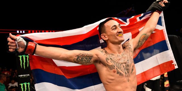 SASKATOON, SK - AUGUST 23: Max Holloway of the United States celebrates after his victory over Charles Oliveira in their featherweight bout during the UFC event at the SaskTel Centre on August 23, 2015 in Saskatoon, Saskatchewan, Canada. (Photo by Jeff Bottari/Zuffa LLC/Zuffa LLC via Getty Images)