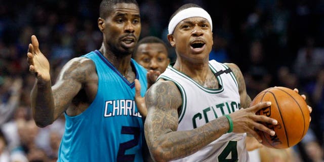 Boston Celtics guard Isaiah Thomas, right, protects the ball from Charlotte Hornets forward Marvin Williams in the second of an NBA basketball game Saturday, Dec. 12, 2015 in Charlotte, N.C. Boston won 98-93. (AP Photo/Nell Redmond)