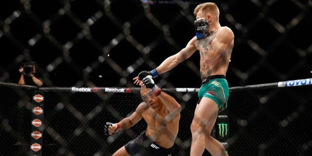 LAS VEGAS, NV - DECEMBER 12: (R-L) Conor McGregor of Ireland punches Jose Aldo of Brazil in their UFC featherweight championship bout during the UFC 194 event inside MGM Grand Garden Arena on December 12, 2015 in Las Vegas, Nevada. (Photo by Christian Petersen/Zuffa LLC/Zuffa LLC via Getty Images)