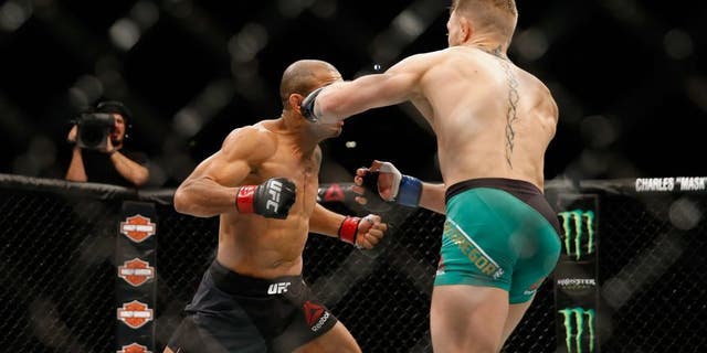 LAS VEGAS, NV - DECEMBER 12: (R-L) Conor McGregor of Ireland punches Jose Aldo of Brazil in their UFC welterweight championship bout during the UFC 194 event inside MGM Grand Garden Arena on December 12, 2015 in Las Vegas, Nevada. (Photo by Christian Petersen/Zuffa LLC/Zuffa LLC via Getty Images)