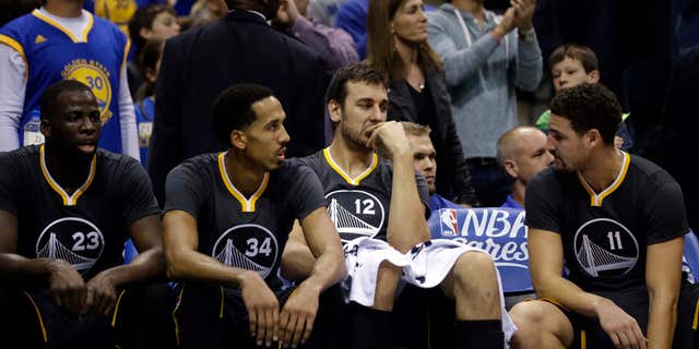 Dec. 12, 2015: Golden State Warriors' Andrew Bogut (12), Klay Thompson (11), Shaun Livingston (34), and Draymond Green (23) talk on the bench during the second half of an NBA basketball game against the Milwaukee Bucks