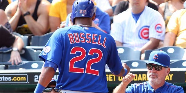 Sep 17, 2015; Pittsburgh, PA, USA; Chicago Cubs manager Joe Maddon (R) greets shortstop Addison Russell (22) after Russell scored a run against the Pittsburgh Pirates during the second inning at PNC Park. Mandatory Credit: Charles LeClaire-USA TODAY Sports