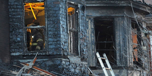 Dec. 14: Firefighters investigate the scene of an early morning two-alarm fire in the 2300 block of Homewood Ave. in East Baltimore.