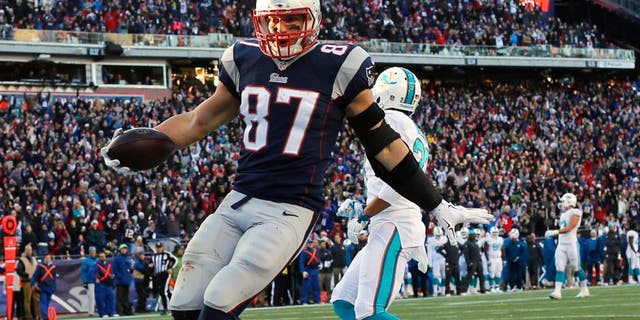 Dec 14, 2014; Foxborough, MA, USA; New England Patriots tight end Rob Gronkowski (87) scores a touchdown during the second half against the Miami Dolphins at Gillette Stadium. The Patriots won 41-13. Mandatory Credit: Winslow Townson-USA TODAY Sports