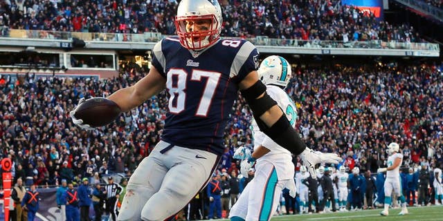 Dec 14, 2014; Foxborough, MA, USA; New England Patriots tight end Rob Gronkowski (87) scores a touchdown during the second half against the Miami Dolphins at Gillette Stadium. The Patriots won 41-13. Mandatory Credit: Winslow Townson-USA TODAY Sports