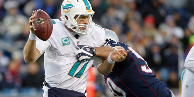 Dec 14, 2014; Foxborough, MA, USA; New England Patriots defensive end Rob Ninkovich (50) tackles Miami Dolphins quarterback Ryan Tannehill (17) during the fourth quarter at Gillette Stadium. The Patriots won 41-13. Mandatory Credit: Stew Milne-USA TODAY Sports