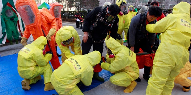 Dec. 15: South Korean hazmat team members wearing anti-chemical suits prepare a civil defense drill from a possible North Korea chemical attack near the border city between the two Koreas in Paju, South Korea.