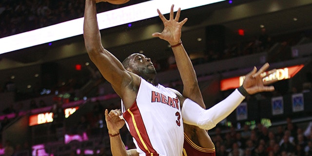 Dec. 15: Cleveland Cavaliers' Joey Graham, right, tries to block Miami Heat's Dwyane Wade from taking a two point shot during the first half of an NBA basketball game in Miami.