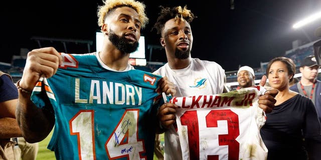 Dec 14, 2015; Miami Gardens, FL, USA; Miami Dolphins wide receiver Jarvis Landry (14) and New York Giants wide receiver Odell Beckham Jr. (13) both display their signed jersey's after their game at Sun Life Stadium. Mandatory Credit: Steve Mitchell-USA TODAY Sports
