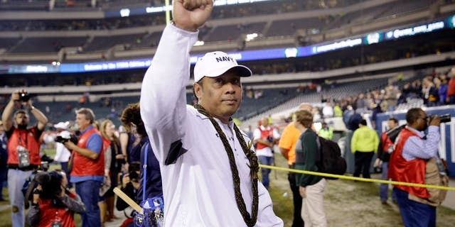 Navy head coach Ken Niumatalolo gestures to fans as he walks off the field after winning 21-17 an NCAA college football game against Army, Saturday, Dec. 12, 2015, in Philadelphia. (AP Photo/Matt Rourke)