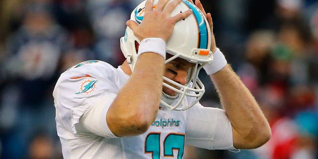 Dec 14, 2014; Foxborough, MA, USA; Miami Dolphins quarterback Ryan Tannehill (17) reacts to a missed pass during the second half against the New England Patriots at Gillette Stadium. The Patriots won 41-13. Mandatory Credit: Winslow Townson-USA TODAY Sports
