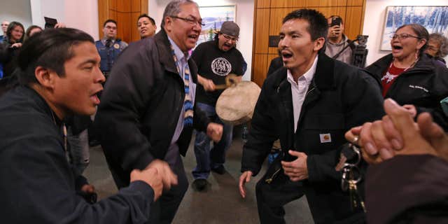 Dec. 17, 2015: Marvin Roberts, right, and Tanana Chiefs Conference President Victor Joseph, left, dance with friends and family at the Rabinowitz Courthouse in Fairbanks, Alaska.