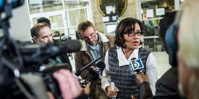 Dec. 15, 2015: A swarm of reporters surround Flint Mayor Karen Weaver to ask question after a news conference at City Hall in Flint, Mich.