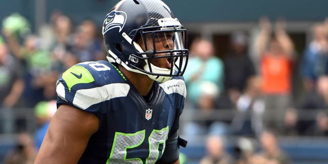 SEATTLE, WA - OCTBER 12: Outside linebacker K.J. Wright #50 of the Seattle Seahawks celebrates after making a stop during the third quarter of the game against the against the Dallas Cowboys at CenturyLink Field on October 12, 2014 in Seattle,Washington. (Photo by Steve Dykes/Getty Images)