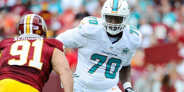Sep 13, 2015; Landover, MD, USA; Miami Dolphins tackle Ja'Wuan James (70) prepares to block Washington Redskins outside linebacker Ryan Kerrigan (91) during the first half at FedEx Field. Mandatory Credit: Brad Mills-USA TODAY Sports