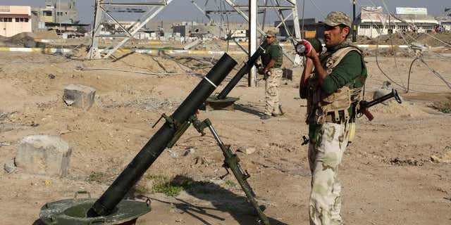 Nov. 30, 2015: Iraqi soldiers prepare to shell Islamic State group positions at the front-line as Iraqi army and allied Sunni volunteer tribal fighters supported by U.S.-led coalition airstrikes are tightened the siege of Ramadi, the capital of Iraq's Anbar province, 70 miles west of Baghdad, Iraq