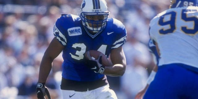 24 Oct 1998: Kalani Sitake #34 of the Bringham Young University Cougars runs with the ball during the game against the San Jose State Spartans at Cougar Stadium in Provo, Utah. BYU defeated San Jose 46-43. Mandatory Credit: Todd Warshaw /Allsport