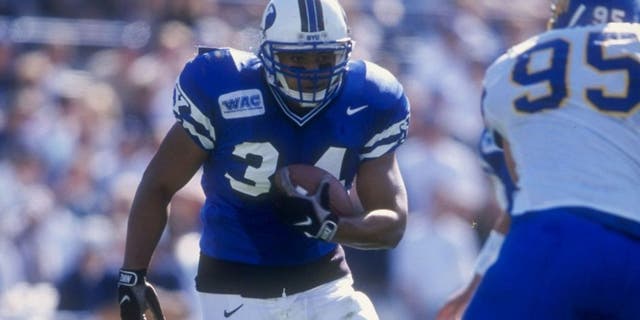 24 Oct 1998: Kalani Sitake #34 of the Bringham Young University Cougars runs with the ball during the game against the San Jose State Spartans at Cougar Stadium in Provo, Utah. BYU defeated San Jose 46-43. Mandatory Credit: Todd Warshaw /Allsport