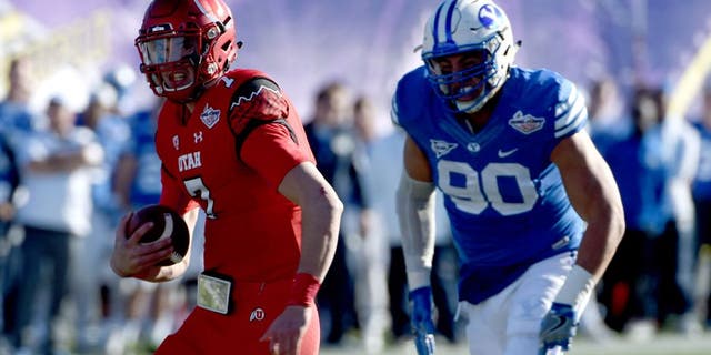 Dec 19, 2015; Las Vegas, NV, USA; Utah Utes quarterback Travis Wilson (7) rushes up the middle as the Utes face off against BYU in the Las Vegas Bowl at Sam Boyd Stadium. Mandatory Credit: Stephen R. Sylvanie-USA TODAY Sports