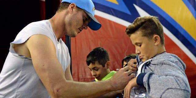 Dec 20, 2015; San Diego, CA, USA; San Diego Chargers quarterback Philip Rivers (17) signs autographs for fans after the Chargers beat the Miami Dolphins 30-14 at Qualcomm Stadium. Mandatory Credit: Jake Roth-USA TODAY Sports