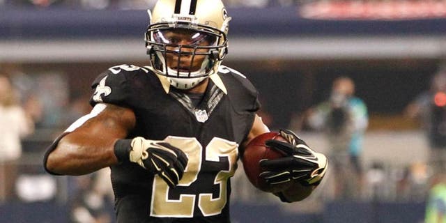 Sep 28, 2014; Arlington, TX, USA; New Orleans Saints running back Pierre Thomas (23) runs the ball against the Dallas Cowboys at AT&T Stadium. Dallas beat New Orleans 38-17. Mandatory Credit: Tim Heitman-USA TODAY Sports